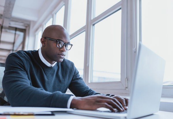 Person typing on a computer.