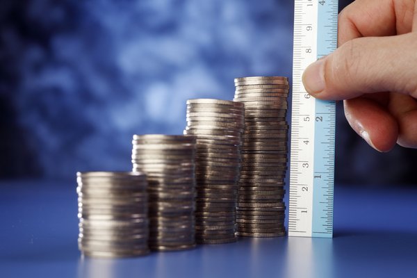 A ruler measuring stacks of quarters.