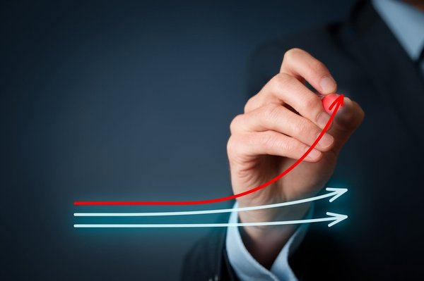 Businessman draws three lines, two straight blue lines and one red line that is trending upward.